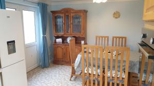 a kitchen with a cabinet and a table and chairs at Gidley Retreat in Heacham