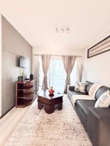 a living room with a couch and a coffee table at Broadacres apartment-work or play -swimming pool in Sandton +31 photos
