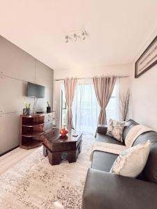 a living room with a couch and a table at Broadacres apartment-work or play -swimming pool in Sandton