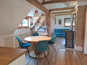 a kitchen and dining room with a table and chairs at Erlhofer Apartments in Tröpolach