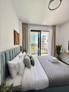 a bedroom with a large bed with a large window at Stay and Chill -Luxury Studio in Kato Paphos in Paphos City