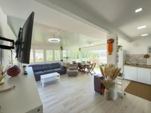a living room with a blue couch and a table at Villa Tarifa in Torrox