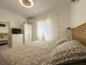 a bedroom with a bed and a dresser and a window at Villa Tarifa in Torrox +13 photos