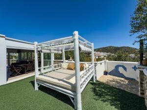 a bed on the back yard of a house at Villa Tarifa in Torrox
