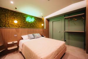 a bedroom with a bed and a green wall at Heaven Room in Striano +94 photos