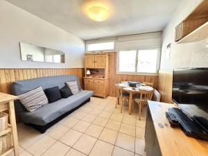 a living room with a couch and a table at Résidence Le Seignon - Studio Confortable au Cœur de Vars MAE-7081 in Vars