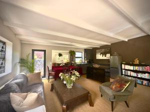 a living room with a couch and a table at Noordhoek Wellness Pilates in Noordhoek
