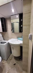 a bathroom with a white sink and a mirror at ApartMorze Apartamenty na Leśnej in Jastarnia +23 photos