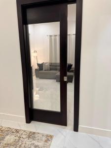 a mirror in a living room with a couch at City Abode Kingston Jamaica in Kingston