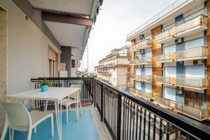 a balcony with a table and chairs and a building at MiniSuites iCostaioli in Maiori