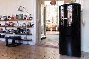 a large black door in a room with a table at Vintage Dome Igloo tent, Lange Haven Schiedam in Schiedam