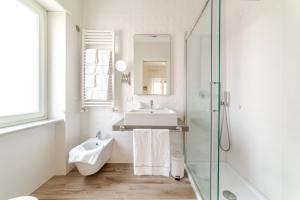 a white bathroom with a sink and a shower at MiniSuites iCostaioli in Maiori +46 photos