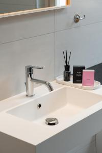 a bathroom sink with a faucet on a counter at Bardolino Suite in Bardolino