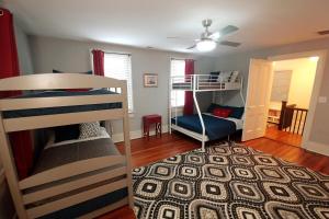 a bedroom with two bunk beds and a living room at 1860 House In the Heart of Downtown in Wilmington