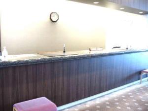 a bar with a sink and a clock on a wall at Natural Farm City Noen Hotel - Vacation STAY 78838v in Chichibu