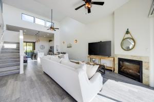 a living room with a white couch and a fireplace at Beachfront 2BR w Deck Views Direct Sand Access Strand Way A in Oceano