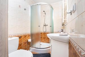 a bathroom with a toilet and a sink and a shower at Willa Emilia in Zakopane +30 photos