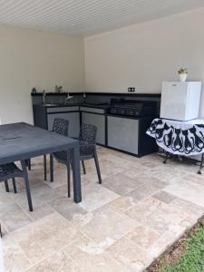 a kitchen with a table and chairs and a stove at Studio près du golf in Montauban