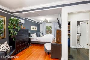 a bedroom with a bed and a dresser at Couple's Oasis at Horner Park in Victoria