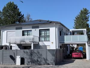 a white house with a fence in front of it at Thermenblick in Bad Aibling