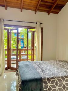 Postel nebo postele na pokoji v ubytování Hospedagem Chris Art Music