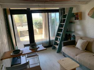 a small living room with a couch and a table at Appartement 300m de la plage in Seignosse