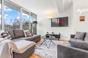 a living room with a couch and a tv at Leeds Balcony Views in the City in Central Station