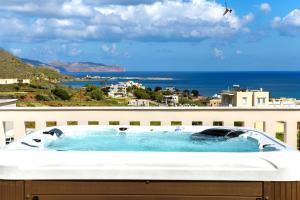 a bath tub with a view of the ocean at Joanna 's Loft in Kissamos