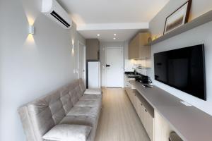 a living room with a couch and a flat screen tv at Smart Home in Sao Paulo