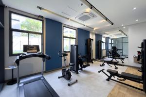 a gym with several treadmills and machines in a room at Smart Home in Sao Paulo