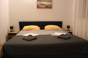 a bedroom with a bed with two towels on it at Rajčić Apartmani in Omiš +17 photos