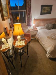 a bedroom with a bed and a table and a chair at The blue international inn in London