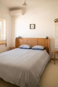 a bedroom with a large bed with two pillows at 2-bedroom house w garden in heart of Ferragudo village in Ferragudo +12 photos