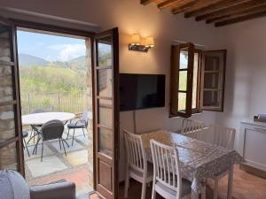 ガイオーレ・イン・キアンティにあるBorgo di Gaiole - Casa Lorenzo - apartment with a view & travel guideのテーブルとテレビのあるキッチンとダイニングルーム