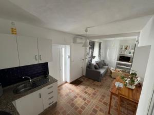 a kitchen and living room with a couch and a table at Casa Patricia II in Arcos de la Frontera