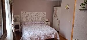 a bedroom with a bed and two night stands at Casa Daniel in Llombera