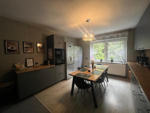 a kitchen with a table and a dining room at Happy 4 in Krosno
