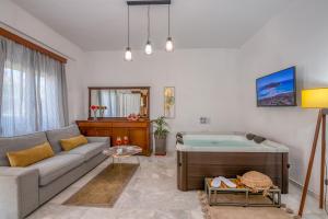 a living room with a couch and a tub at Achilleas Deluxe House-Jacuzzi - BBQ in Kotsianá