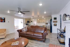 a living room with a leather couch and a kitchen at Mtn-View Home with Patio and Grill in Woodlake in Woodlake