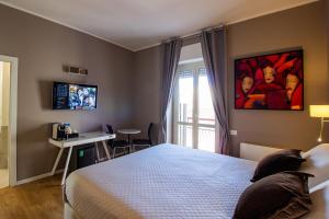 Televízia a/alebo spoločenská miestnosť v ubytovaní Album Boutique Rooms