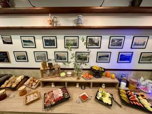 a display of food on a shelf with pictures on the wall at Hostal Regina in Blanes