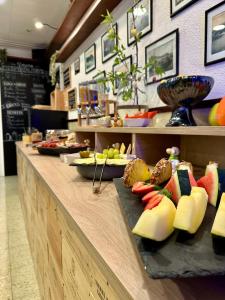 a buffet line with fruits and vegetables on display at Hostal Regina in Blanes