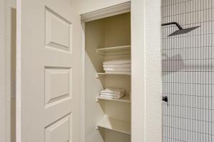a closet with white towels and a door at Southwest Escape in Fort Davis Walk to Dining! in Fort Davis +17 photos