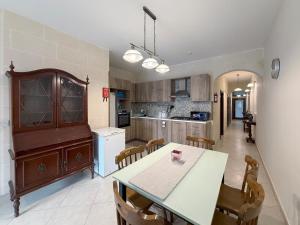 a kitchen with a table and chairs in a room at Seashell Stories - Modern Comforts, Traditional Charm in Nadur +39 photos