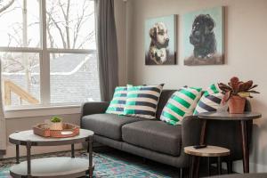 a living room with a couch and two dogs on the wall at Plaza Pad II-Near Plaza District in Oklahoma City
