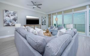 a living room with a large couch and a tv at Phoenix Gulf Towers 806 condo in Gulf Shores +70 photos