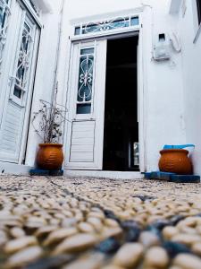 an open door with two pots in front of a building at Stam Luxury Traditional House in Koskinou