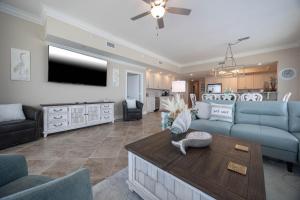 a living room with a couch and a table at Phoenix Gulf Towers 1008 condo in Gulf Shores