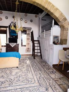 a bedroom with a bed and a chandelier at Stam Luxury Traditional House in Koskinou