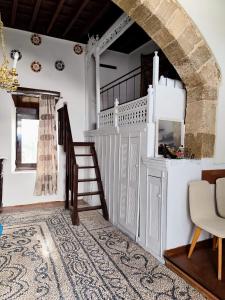 a living room with a staircase and a stair case at Stam Luxury Traditional House in Koskinou +10 photos